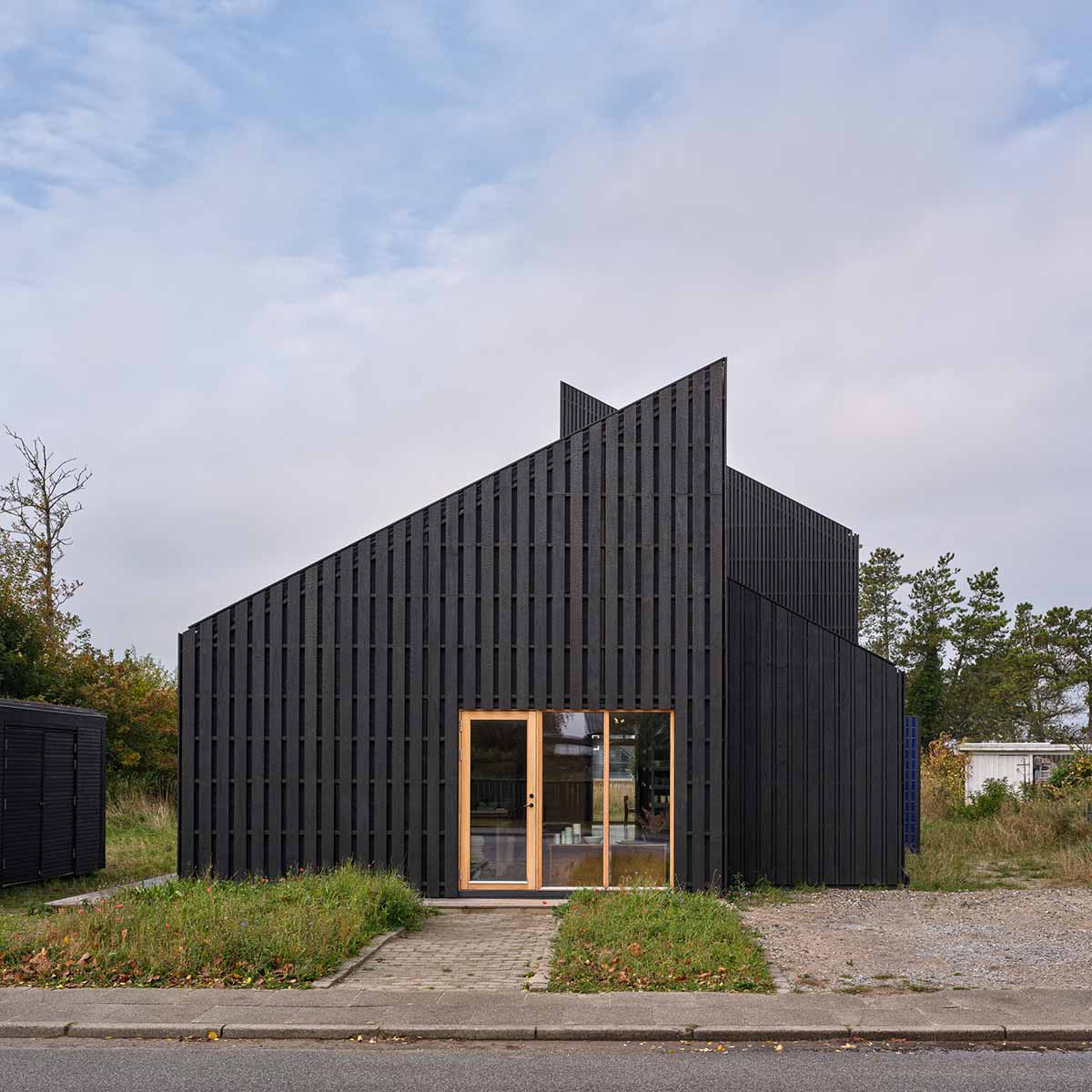 Modern Tversted house in Denmark with charred Accoya wood siding installed by EK Wood, highlighting charred wood textures and sustainable architecture.